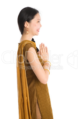 Young girl in Punjabi clothes greeting.