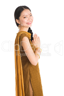 Young girl in Punjabi skirt greeting.