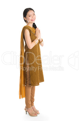 Woman in Punjabi costume greeting.