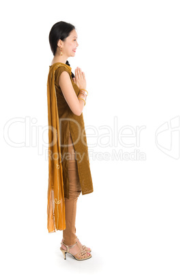 Young girl in Punjabi dress greeting.