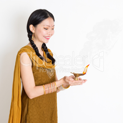 Woman holding oil lamp