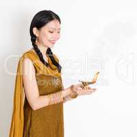 Woman holding oil lamp