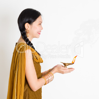 Woman holding Diwali diya light