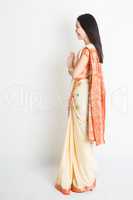 Side view woman in Indian sari dress greeting