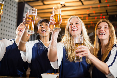 Group of friends holding glass of beer in party