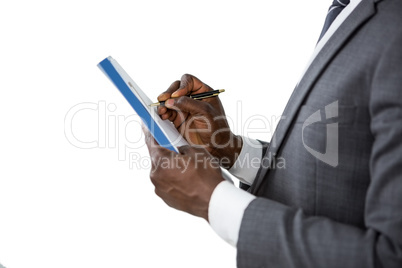 Hands of a man signing insurance document