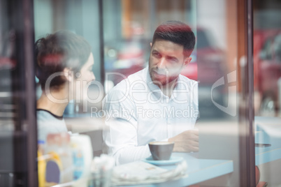 Businesspeople interacting while having coffee