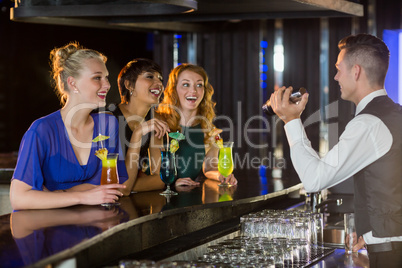 Waiter interacting with beautiful women