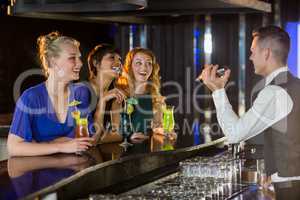 Waiter interacting with beautiful women