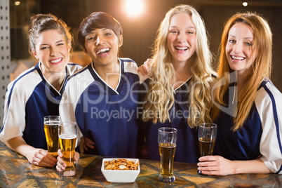 Group of friends having glass of beer in party