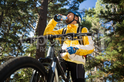 Male mountain biker drinking water