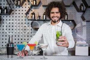 Bartender serving glass of gin