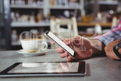 Hand of man holding mobile phone