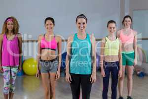 Portrait of group of fitness team standing in fitness studio