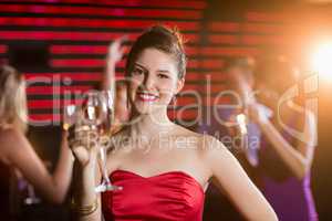 Portrait of young woman holding a glass of champagne