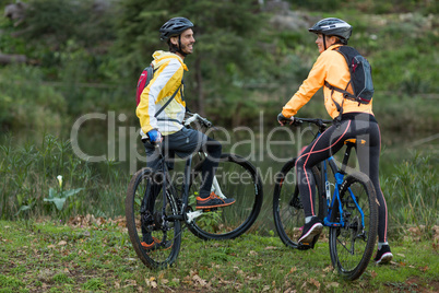Biker couple interacting with each other with mountain bike
