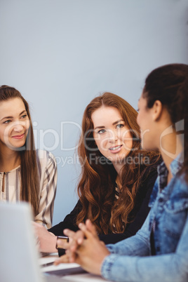 Businesswomen discussing at desk