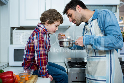 Father and son cooking food together