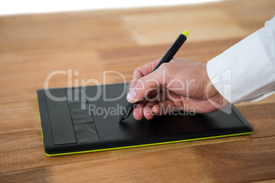 Hand of graphic designer using graphic tablet