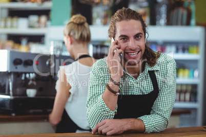 Portrait of waiter talking on mobile phone