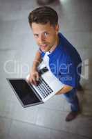 Portrait of handsome man using laptop