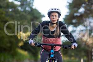 Female biker cycling in countryside