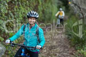 Female biker standing with mountain bike