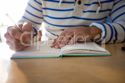 Man writing in a diary