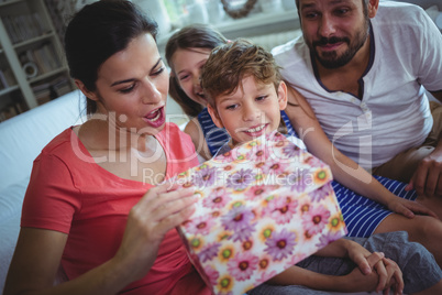 Family opening the surprise gift  in living room