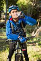 Male mountain biker drinking water