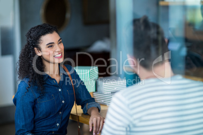 Smiling young couple interacting in cafÃ?Â©