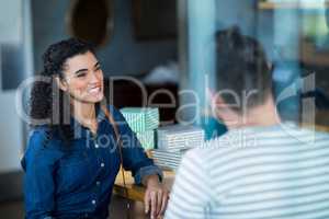 Smiling young couple interacting in cafÃ?Â©