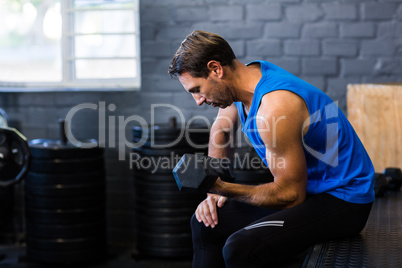 Young man exercising with dumbbell