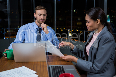 Businessman and businesswoman working in office