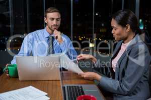 Businessman and businesswoman working in office