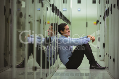 Technician sitting on floor in server room