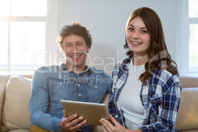 Couple holding digital tablet