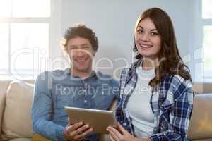 Couple holding digital tablet