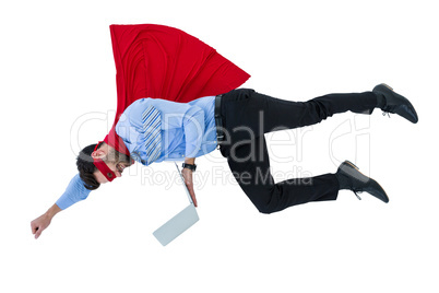 Businessman pretending to be a super hero holding laptop