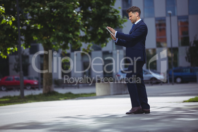 Handsome businessman using digital tablet