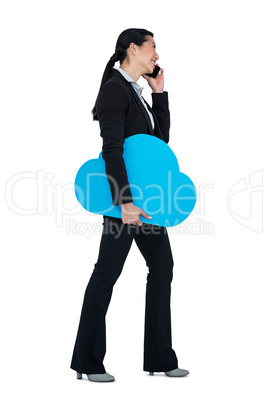 Smiling businesswoman talking on mobile phone against white background