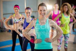 Group of women standing with hands on hips