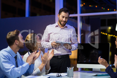 Businesspeople applauding on their colleagues presentation