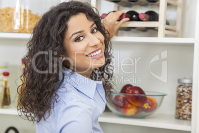 Woman Reaching for Bottle of Red Wine on Rack
