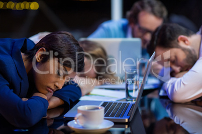 Tired businesspeople sleeping in office