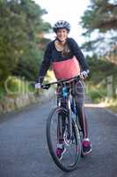 Female biker with mountain bike in countryside