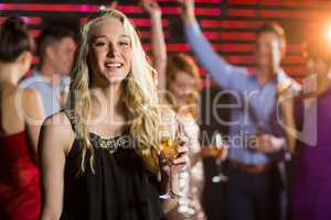 Portrait of young woman holding a glass of champagne