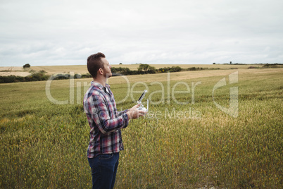 Farmer using agricultural device while examining in field