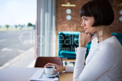 Woman sitting in cafeteria