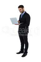 Businessman using laptop at his desk